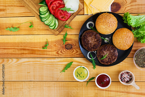 Ingredients for burger on wooden background. Top view