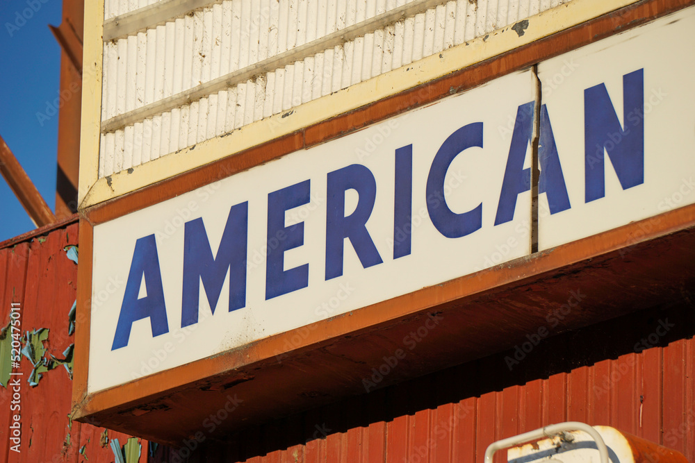 Old worn American sign on building