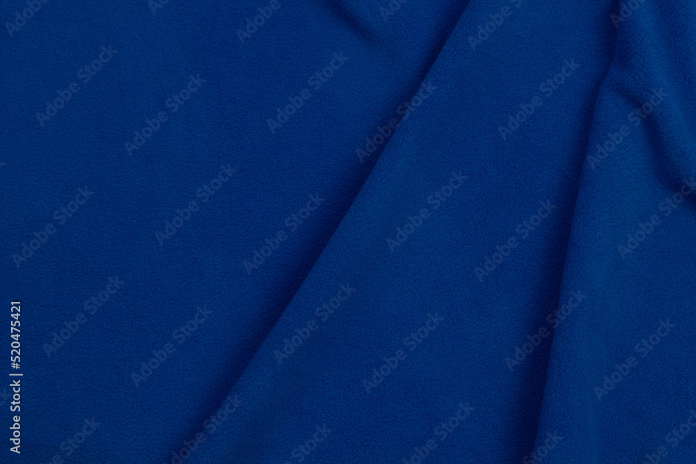Fleece fabric blue top view. Texture of textile fleece bedspread. Fleece fabric blue top view. Texture of textile fleece bedspread.