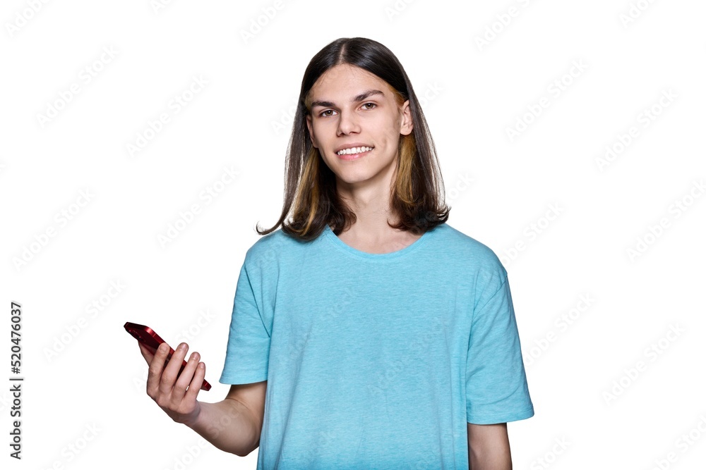 Teenager guy with smartphone in his hands on white isolated background Teenager guy with smartphone in his hands on white isolated background