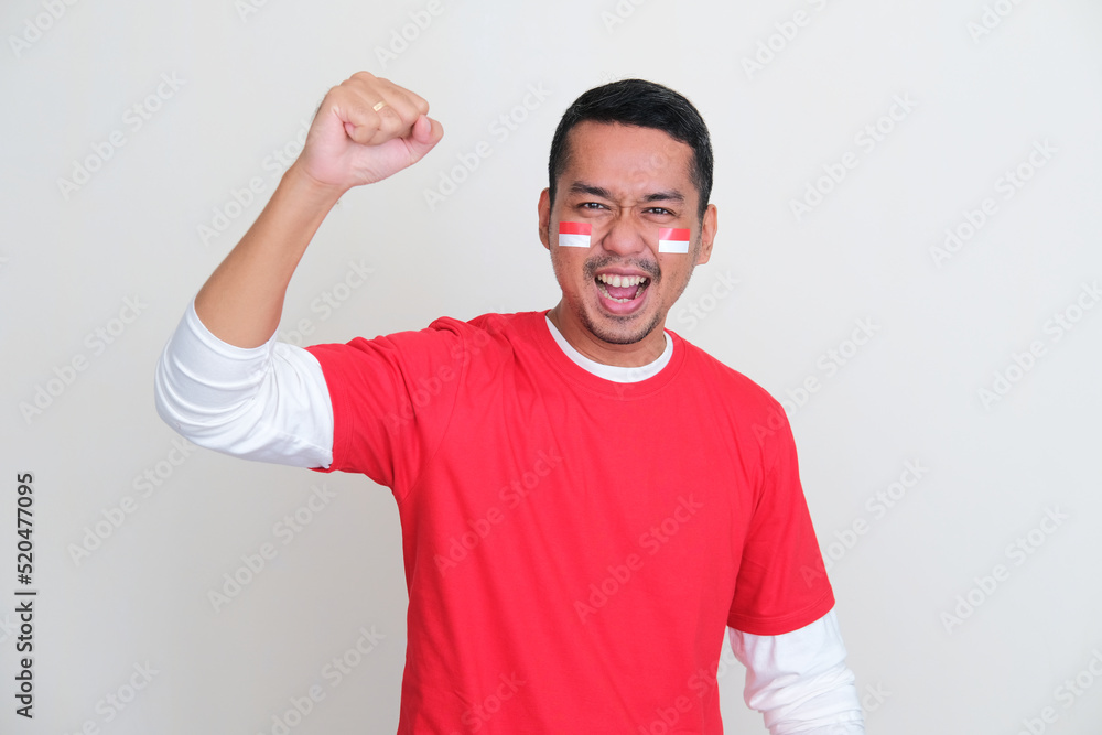 Fototapeta premium Indonesian man showing excited expression during independence day celebration
