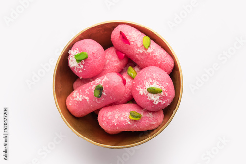 Pink Chumchum or rose flavoured chum chum or cham cham, indian and pakistani sweet photo