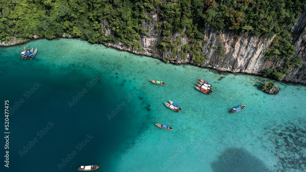 Long boats in paradise. Crystal clear waters of the Phi Phi islands. Travel to Thailand