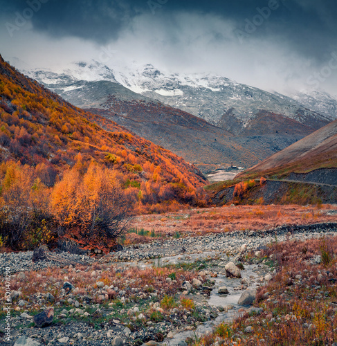 Gloomy autumn view of Caucasus mountains. Orange mountain hills of Upper Svaneti, Georgia, Europe. Beauty of nature concept background..