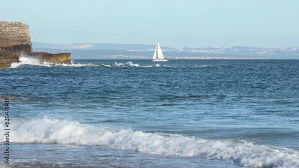 Tourist speed boat riding along a beautiful coast in Cascais province behind of fort saint Julian, Portugal Tourist speed boat riding along a beautiful coast in Cascais province behind of fort saint Julian, Portugal