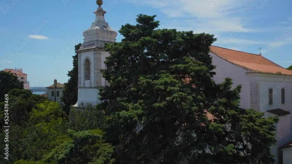 Aerial orbit drone shot of bell appearing after tree of São Jorge Castle in Lisbon on sunny day Aerial orbit drone shot of bell appearing after tree of São Jorge Castle in Lisbon on sunny day
