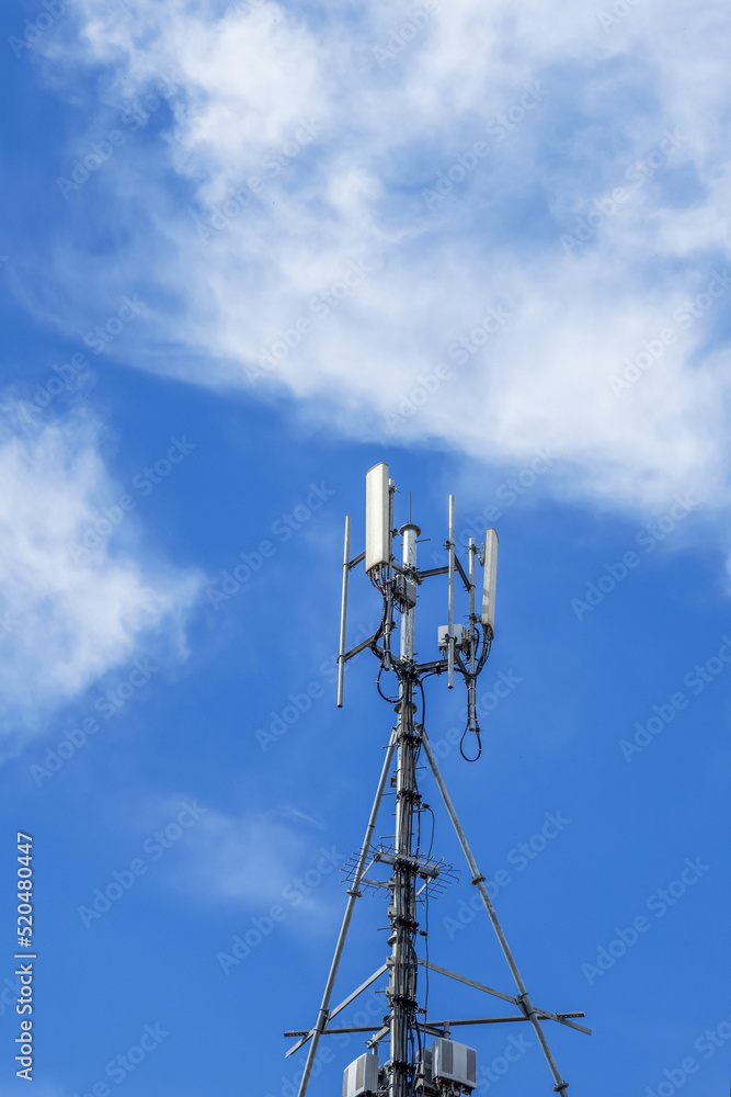 Communications tower with antennas against blue sky Communications tower with antennas against blue sky