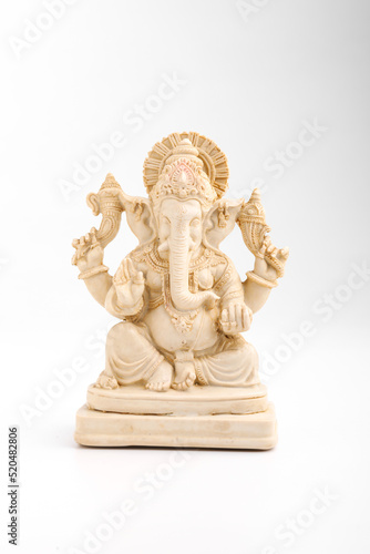 antique lord ganesha sculpture on white background. © PRASANNAPIX