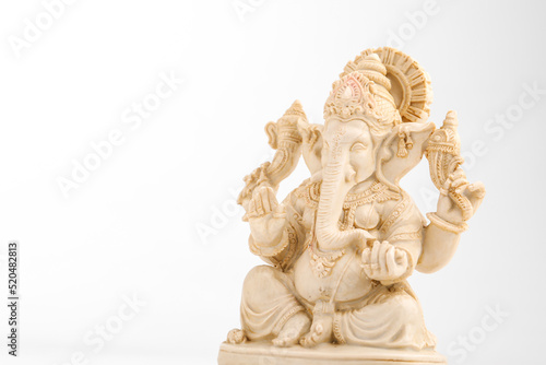 antique lord ganesha sculpture on white background.