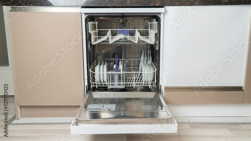 Open dishwasher with dishes on the bottom shelf