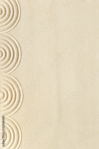 Top view pattern in Japanese Zen Garden with close up concentric circles on sand for meditation and relaxation. Aesthetic minimal sand background with copyspace, beige neutral tones.