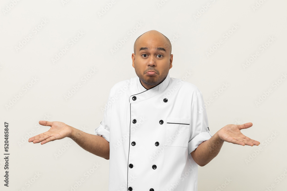 Pretend not to understand Young handsome asian man chef in uniform standing on isolated background. Confused Cooking indian man Occupation chef or baker People in kitchen restaurant and hotel. Pretend not to understand Young handsome asian man chef in uniform standing on isolated background. Confused Cooking indian man Occupation chef or baker People in kitchen restaurant and hotel.