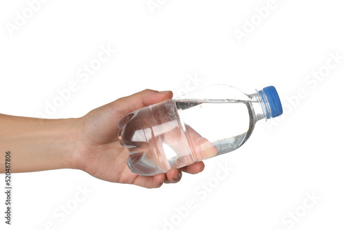 Female hand holds bottle of water, isolated on white background photo