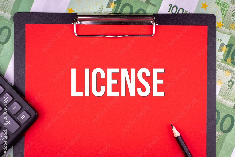 LICENSE - word on the background of money, a notepad and a pencil with a calculator. Business concept (copy space). LICENSE - word on the background of money, a notepad and a pencil with a calculator. Business concept (copy space).
