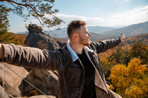 man hiker taking selfie on the top of dovbush rocks Ukraine photo