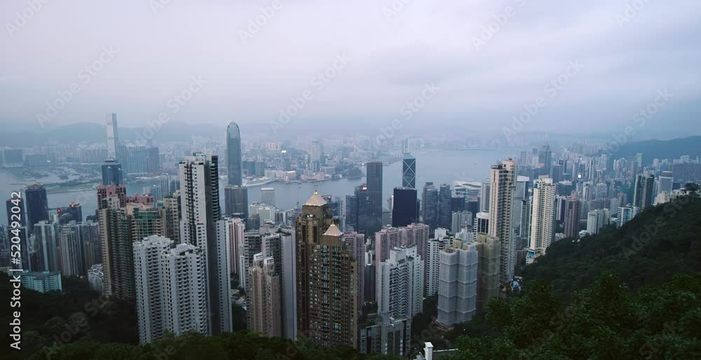 Wide pan across downtown Hong Kong on cloudy evening at dusk Wide pan across downtown Hong Kong on cloudy evening at dusk
