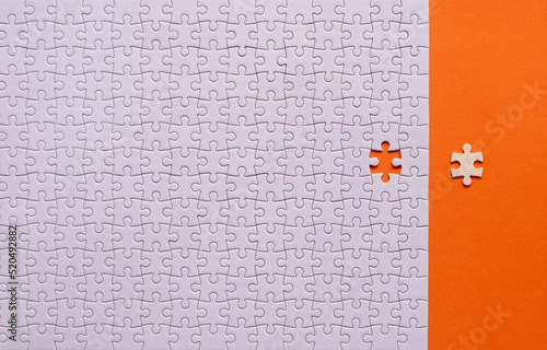 Jigsaw puzzle white color,Puzzle pieces grid,Success mosaic solution template,Horizontal on orange background copy space for text,Top view