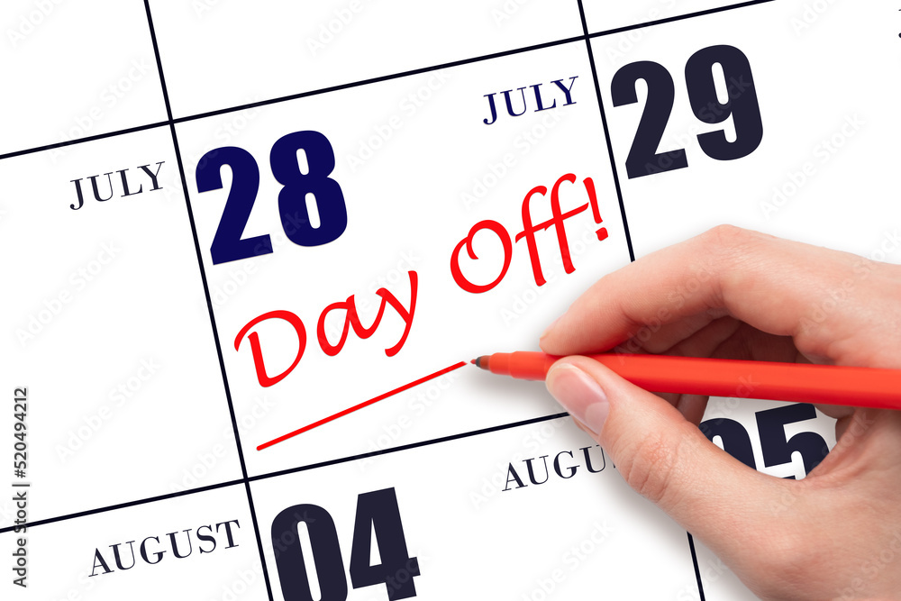 28th day of July. Hand writing text DAY OFF and drawing a line on calendar date 28 July. Vacation planning concept. Summer month, day of the year concept. 28th day of July. Hand writing text DAY OFF and drawing a line on calendar date 28 July. Vacation planning concept. Summer month, day of the year concept.