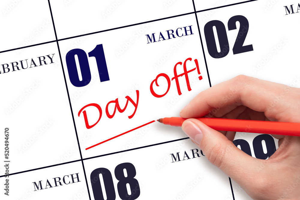 1st day of March. Hand writing text DAY OFF and drawing a line on calendar date 1 March. Vacation planning concept. Spring month, day of the year concept. 1st day of March. Hand writing text DAY OFF and drawing a line on calendar date 1 March. Vacation planning concept. Spring month, day of the year concept.