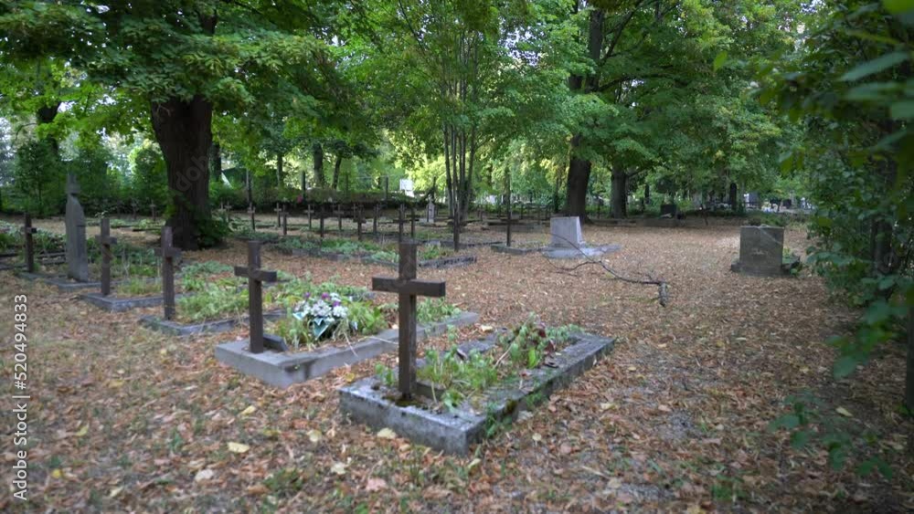 Zooming in on crosses in graveyard with graves of soldiers lost in war Zooming in on crosses in graveyard with graves of soldiers lost in war