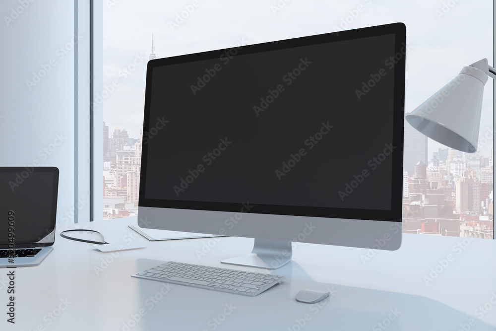 Close up of creative designer desktop with empty black mock up computer monitor laptop and supplies in modern office with window and panoramic city view. 3D Rendering. Close up of creative designer desktop with empty black mock up computer monitor laptop and supplies in modern office with window and panoramic city view. 3D Rendering.