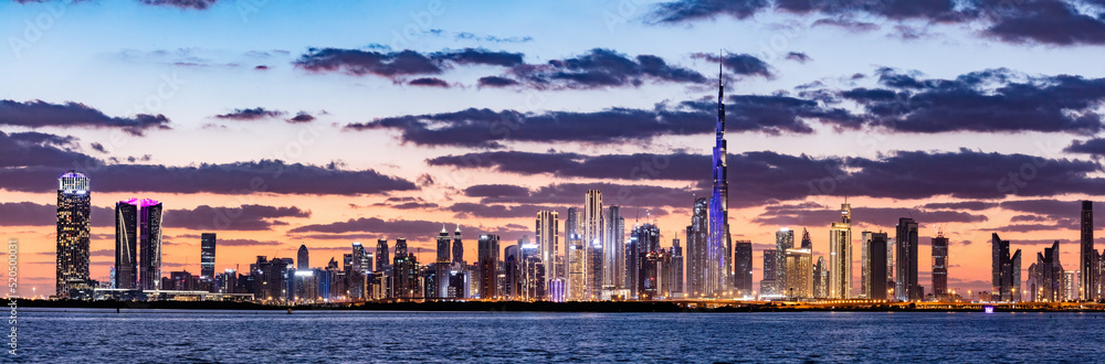 Skyscrapers skyline of Dubai UAE downtown with Burj Khalifa at sunset ...