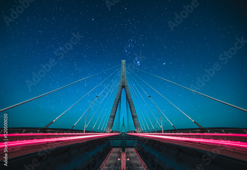 Fotografie, Obraz Long exposure from the middle of the suspension bridge, passage of vehicles and