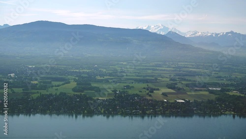 Swiss coast of Geneva (Leman) lake around Anieres with the Mont Blanc and the Alps in the background, aerial view