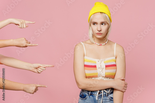 Tableau sur toile Young sad unhappy caucasian blond lesbian woman 20s she wear colorful knitted top yellow hat blamed by society isolated on plain pastel light pink background