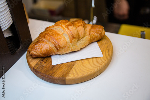Fresh croissant on a wooden board