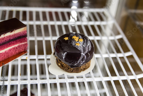 Beautiful chocolate cake in the refrigerator in a cafe