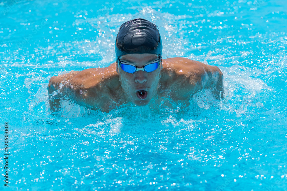 custom made wallpaper toronto digitalClose up action shot of athlete, young man, teenager swimming butterfly style. Sport, recreation concept. Selective focus.