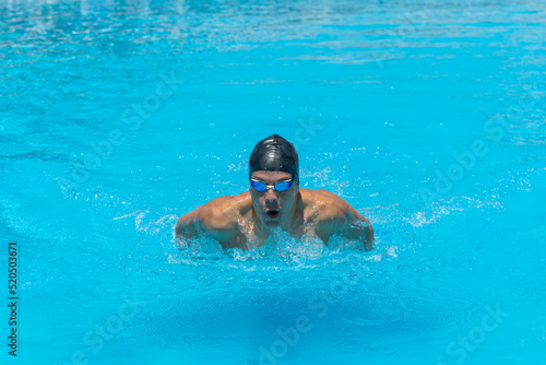 Wallpaper Mural Close up action shot of athlete, young man, teenager swimming butterfly style. Sport, recreation concept. Torontodigital.ca