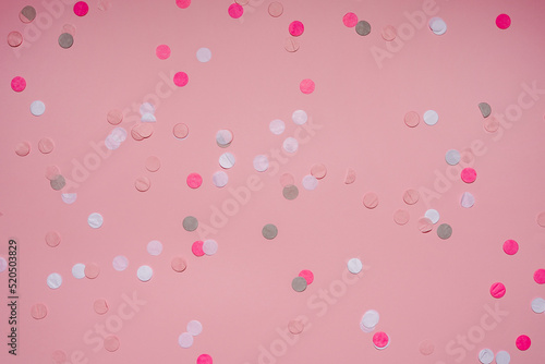 Party colorful confetti over pink background . Top view, flat lay