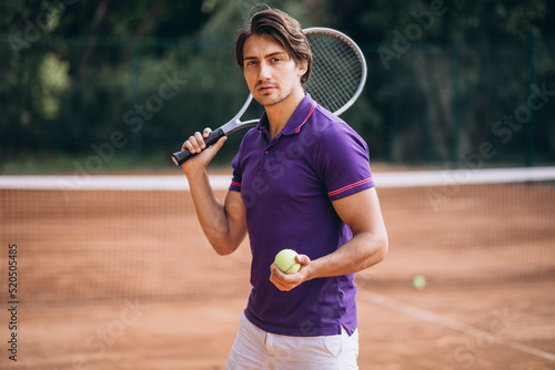 Young man tennis player at the court © Petro