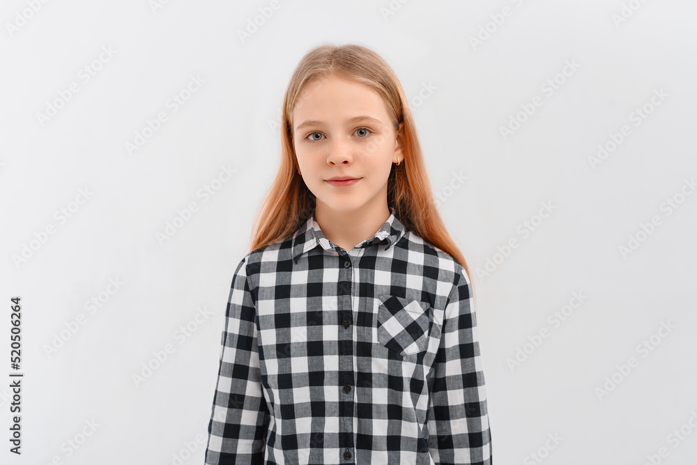 Portrait of teen girl with fair-haired looking at camera, standing in casual shirt. Indoor studio shot on white background Portrait of teen girl with fair-haired looking at camera, standing in casual shirt. Indoor studio shot on white background