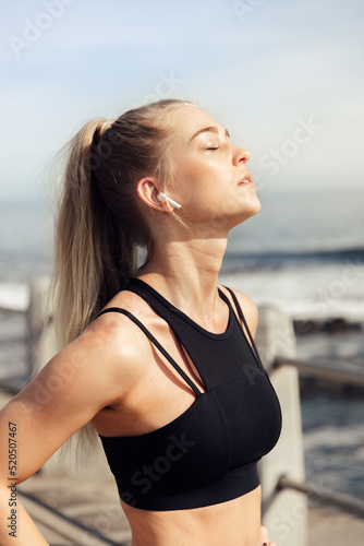 Tired woman with eyes closed standing against sky © Timm Creative