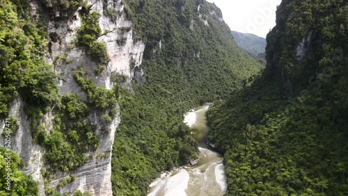 Beautiful aerial scenic view over high cliff to Fox River in New Zealand native forest photo