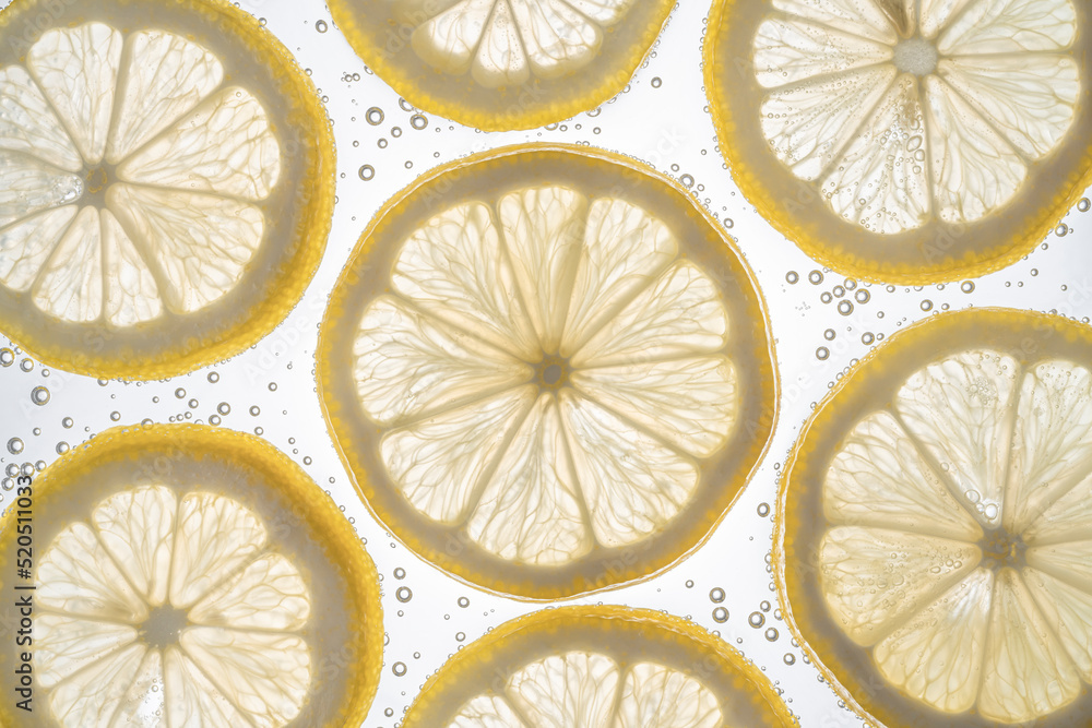Fresh lemon slice in water with bubbles on white background Fresh lemon slice in water with bubbles on white background