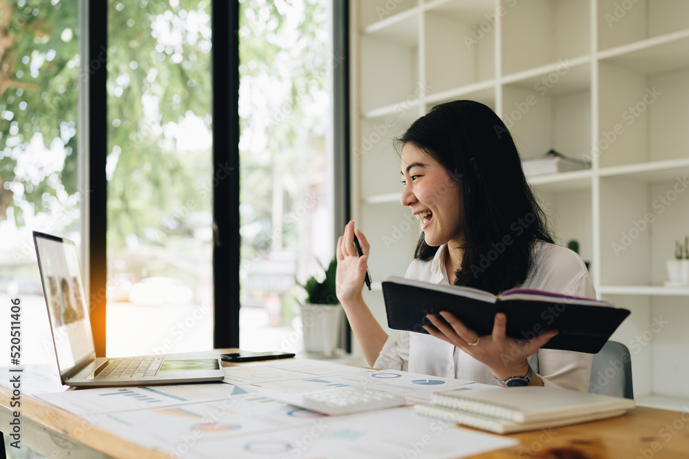 Asian business woman on a video call by laptop. Online meeting concept. Asian business woman on a video call by laptop. Online meeting concept.