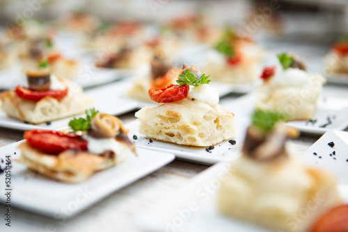 Valokuvatapetti pieces of Italian focaccia with anchovies on a wedding banquet