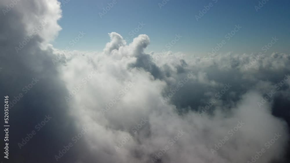 Aerial view. The drone flies over foggy and fluffy clouds. Blue sky sun and sea fog. Abstract aerial nature summer ocean sunset sea and sky background. Vacation, vacation and holiday concept Aerial view. The drone flies over foggy and fluffy clouds. Blue sky sun and sea fog. Abstract aerial nature summer ocean sunset sea and sky background. Vacation, vacation and holiday concept