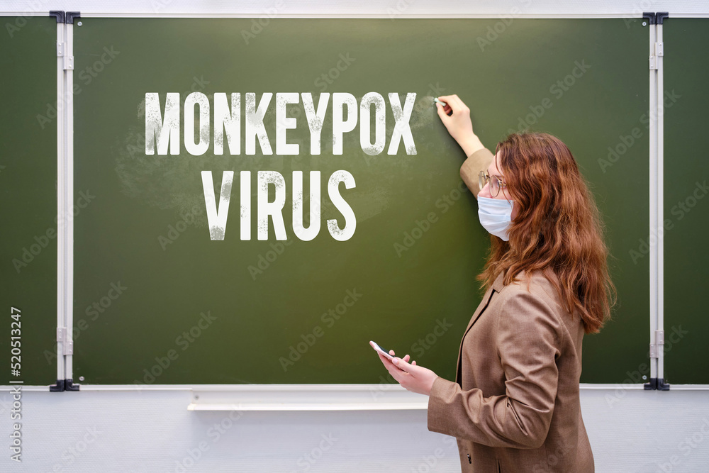 School teacher and inscription monkeypox virus, quarantine due to disease pandemic. School board and text monkeypox, viral epidemic School teacher and inscription monkeypox virus, quarantine due to disease pandemic. School board and text monkeypox, viral epidemic