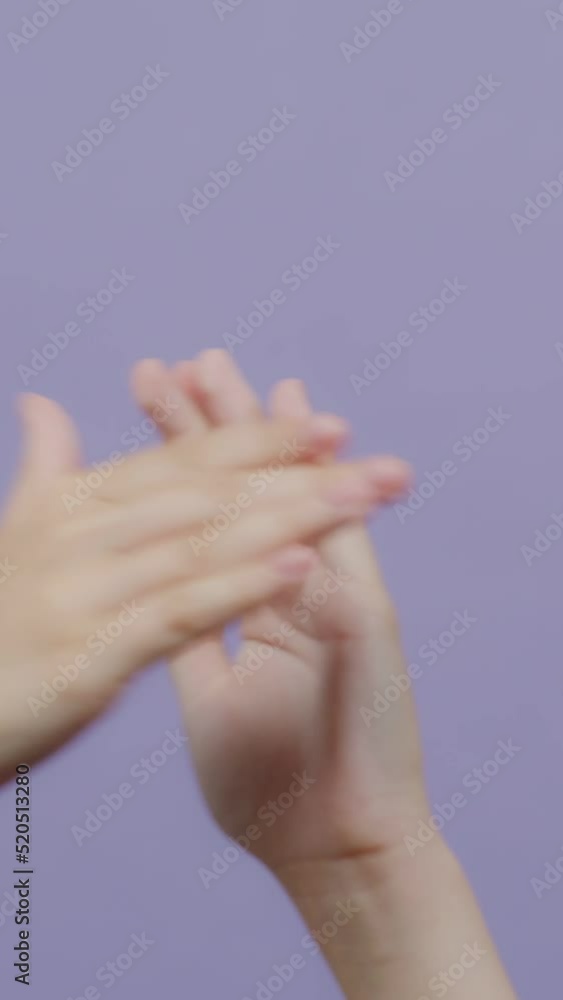 Two female hands with fair skin appear and clap. Two female hands with fair skin appear and clap.