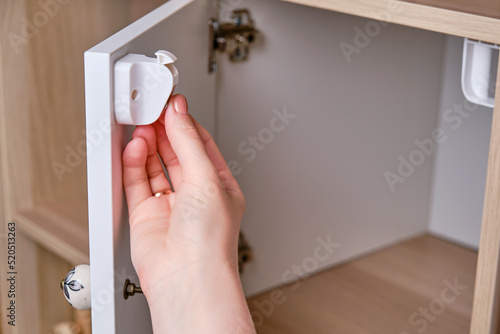 Installing a child-proof magnetic lock to protect cabinet doors and drawers of home furniture
