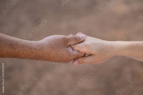 Caucasian hands holding. Man helping his wife to stand up with some tenderness © Julia