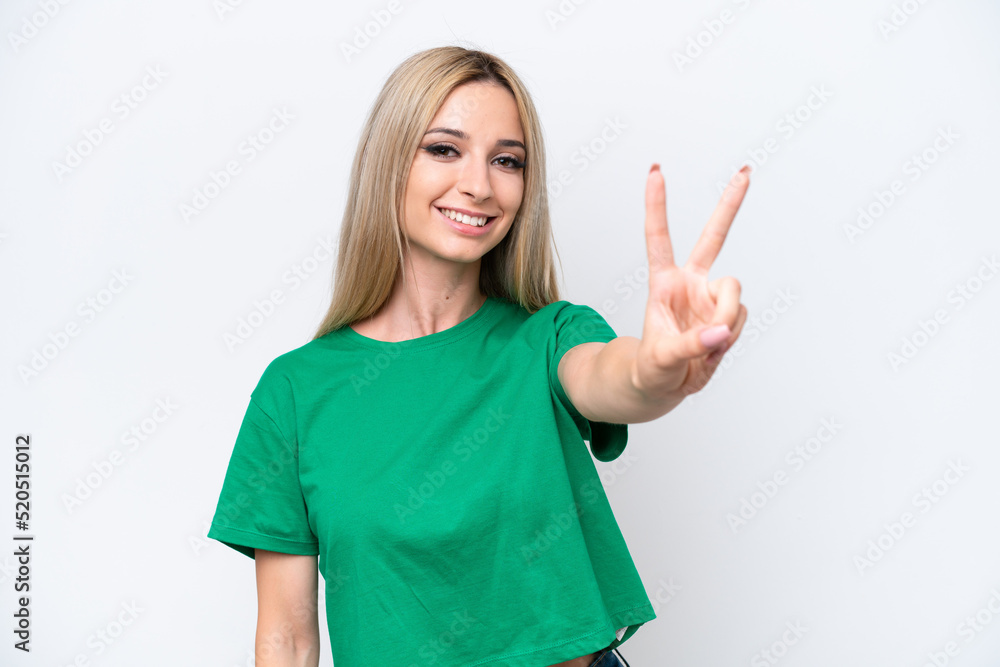 Pretty blonde woman isolated on white background smiling and showing victory sign Pretty blonde woman isolated on white background smiling and showing victory sign