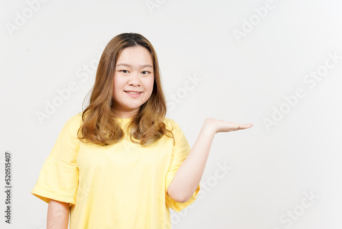 Showing and Presenting Product on Open Palm of Beautiful Asian Woman wearing yellow T-Shirt