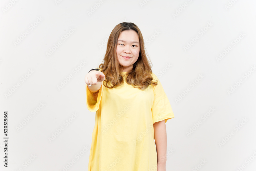 Pointing at you and smile of Beautiful Asian Woman wearing yellow T-Shirt Isolated On White Pointing at you and smile of Beautiful Asian Woman wearing yellow T-Shirt Isolated On White