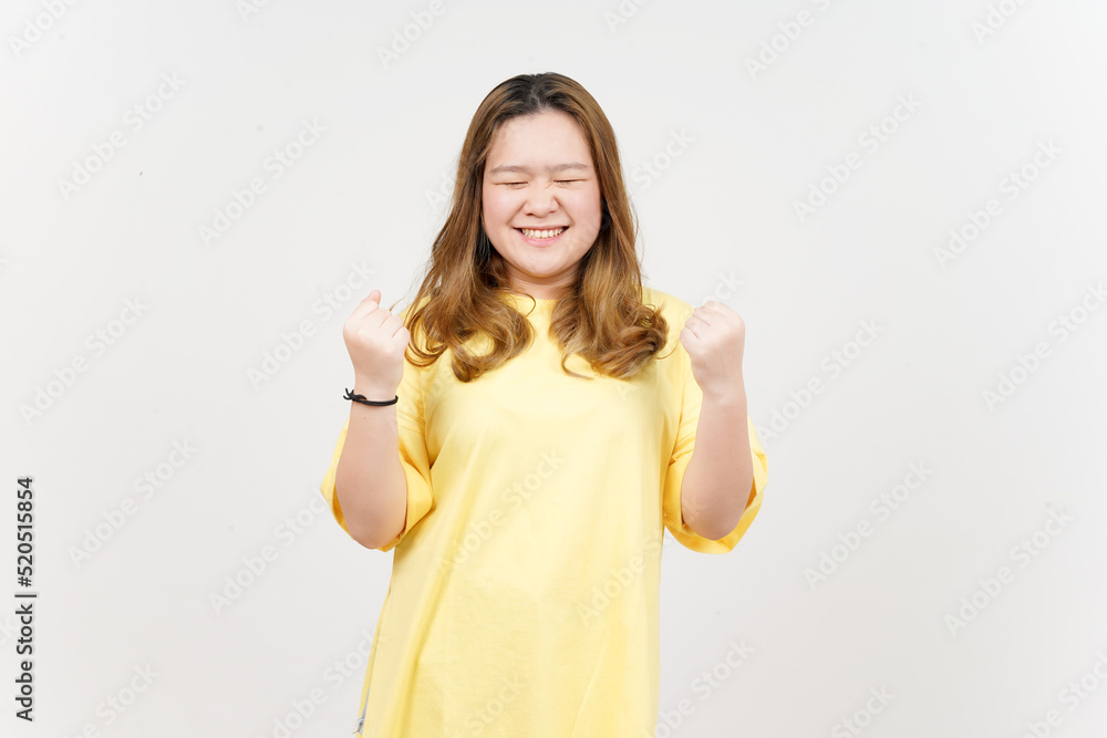Yes Celebration gesture of Beautiful Asian Woman wearing yellow T-Shirt Isolated On White Background Yes Celebration gesture of Beautiful Asian Woman wearing yellow T-Shirt Isolated On White Background